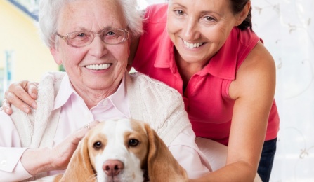 Photo of Older Adult with Young Woman with dog. 