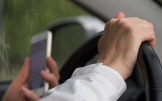 person driving while texting. 