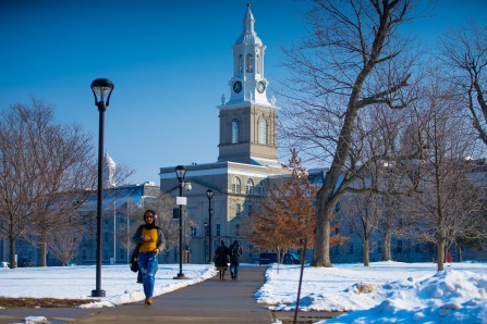 Students walking in front of Hayes Hall on a sunny winter day. 