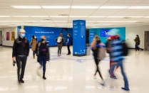 Students walking through a campus hallway. 