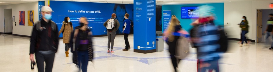 Students walking through a campus hallway. 