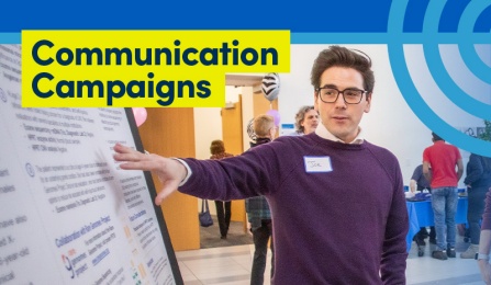 Person pointing to a poster board. 