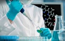 Scientist using a pipette to inject chemicals into test tube. 