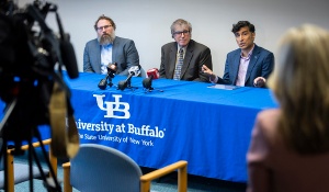 UB political science sit a table, with the UB logo, addressing the media following Election Day. 