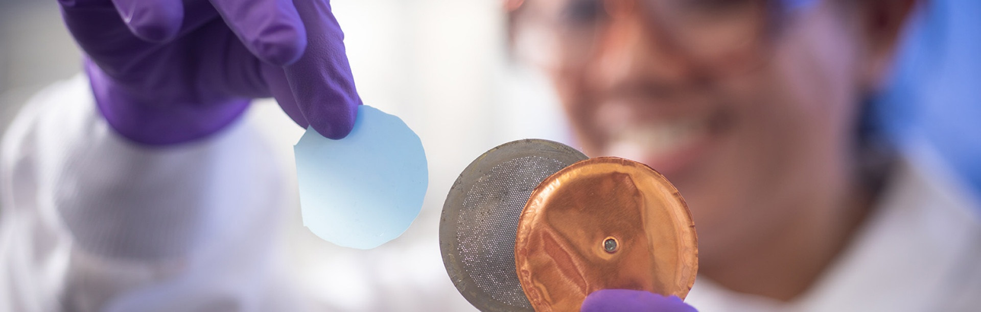 researcher holding manufacturing materials. 