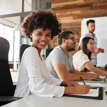 diverse college students using laptop and talking, learning exchanging ideas. 