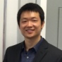 Photo of Yingjie Hu. Headshot of man with short black hair in a suit smiling at the camera. 