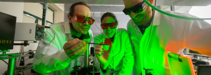 Paras N. Prasad (left), a SUNY Distinguished Professor of Chemistry, Physics, Medicine and Electrical Engineering works with students in a chemistry lab in the Natural Sciences Complex. 