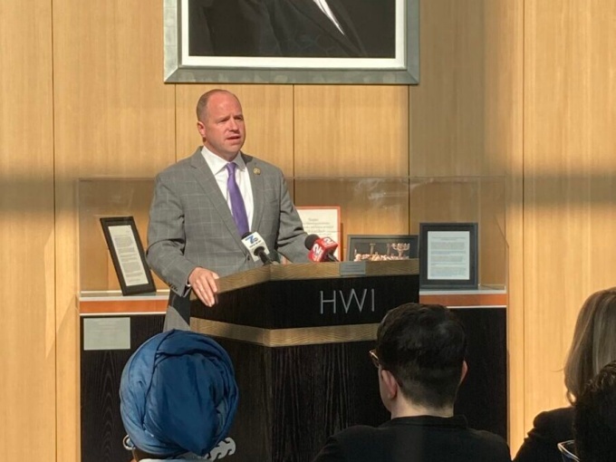 Congressman Kennedy standing at an HWI podium speaking. 
