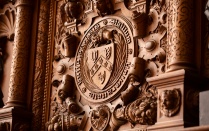 UB seal carved into a fireplace surround. 