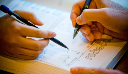 Two students working on chemistry homework. 