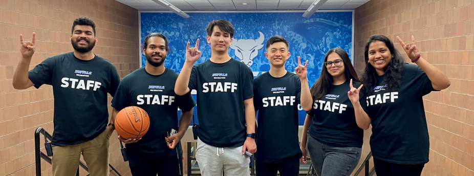 REC student staff posing with "horns-up" hands. 