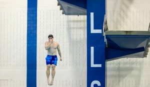 UB Student jumping from the diving platform during Take the Plunge.