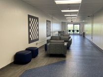 UB Recreation Lounge study area featuring couches, ottomans, high-top tables and window seating. 