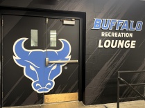 Entrance to the UB Recreation Lounge featuring the UB Bulls logo across black double doors.