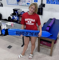 Faith Hamilton holding a life preserver that says "Guard of the Week".