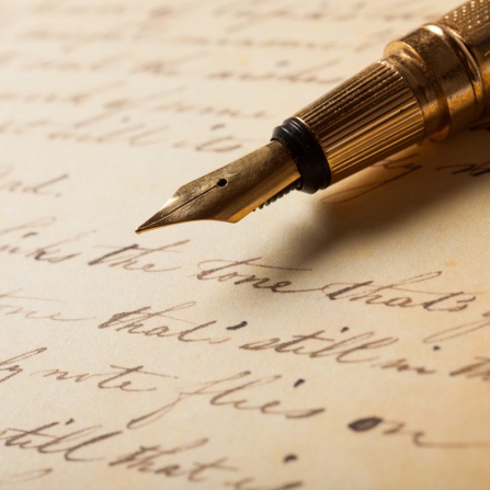 Fountain pen on an antique handwritten letter. 