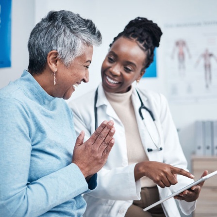 Doctor discussing test results with patient in exam room. 