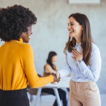 ORA specialist shaking hands with a researcher that is beginning the grant proposal process. 