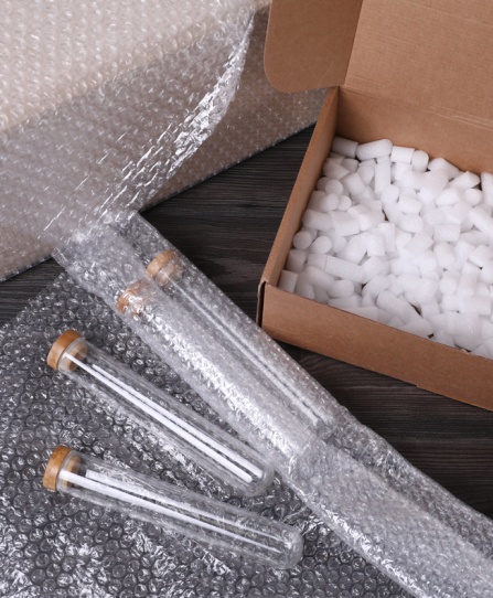 Test tubes with bubble wrap and cardboard box. 