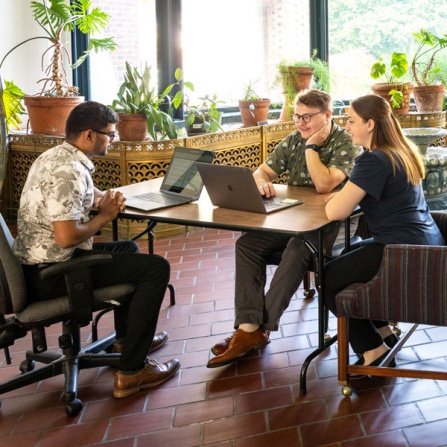 Students with the Social Impact Fellows Management student Ajit Pawar, political science student Nicholas Bush and social work student Abbey Szarowicz chose a project based at the International Institute of Buffalo. The Social Impact Fellows (SIF) program prepares students to address social issues using principles of entrepreneurship and social innovation. They were photographed at their location at the IIB in downtown Buffalo in July 2024. The Social Impact Fellows program brings together graduate students from the School of Management, School of Social Work, College of Arts and Sciences, and the School of Public Health and Health Professions to create social innovation in Western New York. Photographer: Meredith Forrest Kulwicki. 