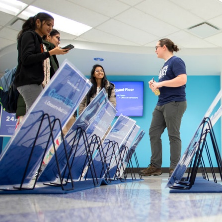 Student representatives of the Career Design Center host a pop-up event in Capen Hall in January 2024. They hosted a game of Guess Who? and showed visitors the new Connect-A-Bull mentoring program online. Photographer: Meredith Forrest Kulwicki. 