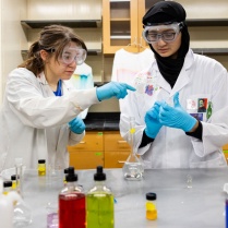 UB student Madison Williams works with Niagara Falls High School junior Hajira Imran in a chemistry lab in the Natural Sciences Complex in July 2024. This was part of &ldquo;Girls in STEM, Together we CHEM," a summer camp program developed by Emanuela Gionfriddo, with chemistry, which gave students in eighth through 12th grades the opportunity to talk with female scientists, run experiments and share their discoveries. Photographer: Meredith Forrest Kulwicki. 