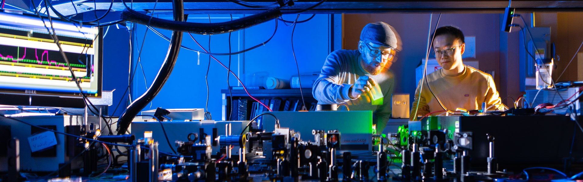 Tim Thomay, with physics, works with a student in his lab in Fronczak Hall in November 2023. Photographer: Douglas Levere. 