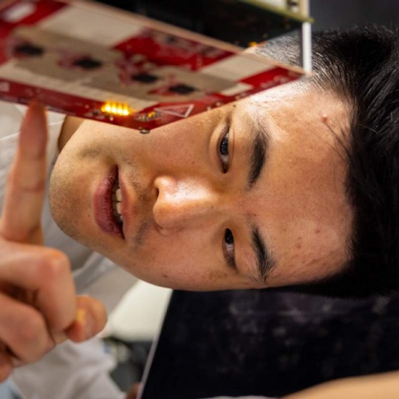 Researcher working with electronic component. 