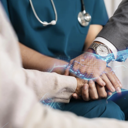 A close-up scene shows a healthcare professional wearing blue medical scrubs and a stethoscope around their neck and a patient sitting together, with their hands gently clasped in a supportive gesture. 
