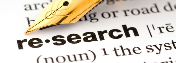 pen and paper with research written large. 