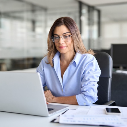 Researcher using laptop to search for grant opportunities online. 