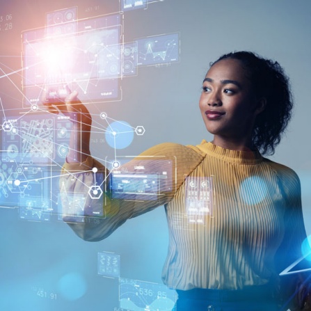 Woman working with a virtual digital screen managing a computer interface. Vectors, icons and binary code line art graphics appear in ana overlay. 