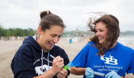 Lauren Sassoubre and Hailie Suk collecting water samples at WoodLawn Beach. 