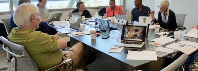 Discussion at a meeting around a table.