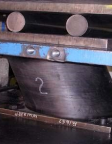 Testing of a single elastomeric bearing in the large bearing testing machine. 