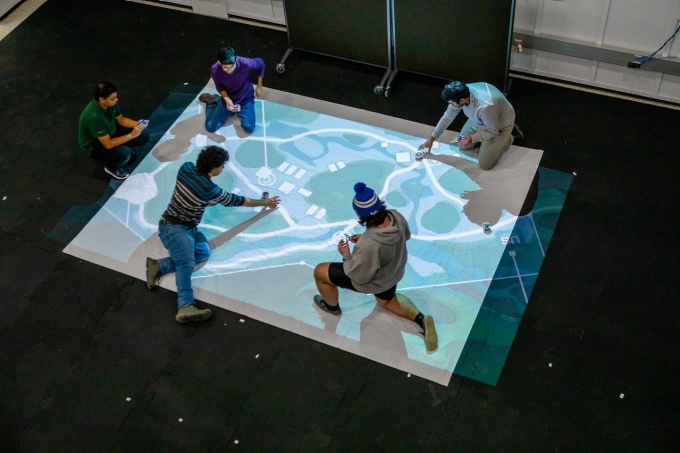 Inside UB's SMART Motion Capture Lab, students create a simulated environment to demonstrate how autonomous air and ground robots can work together. Photographed in December 2019 in Bonner Hall. The research team, led by David Doermann, Eshan Esfahani and Karthik Dantu,received a federal grant to study the decisions people make while gaming.\r\rPhotographer: Douglas Levere. 