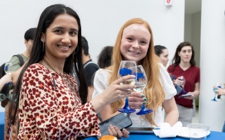 Student graduates share in a commemorative toast. 