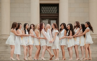 Alpha Sigma Tau in graduation dresses. 