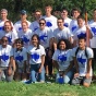 Leadership House students pose in white shirts with a blue buffalo on them in front of the gardens at the Erie County Botanical Garden. 