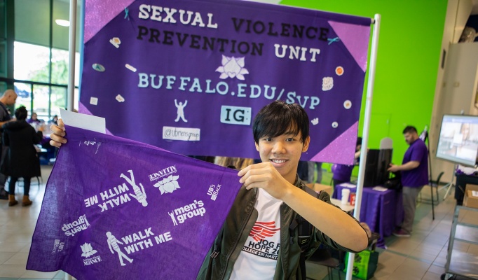 The UB Men's Group and the Student Survivor Advocacy Alliance handed out purple bandanas in the Student Union on Wednesday in support of UB's Walk With Me. Photographer: Douglas Levere. 