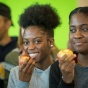 Students eating apples in the Union. 