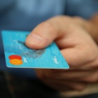 A person holding a credit card. 