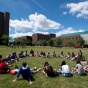 new u b students gathered in a circle outside at orientation. 