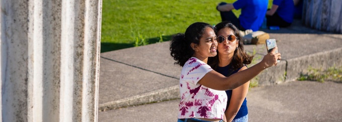 International students gather for group selfie next to Baird Point. 