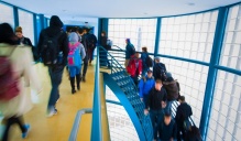 photo of students walking between classes in NSC hallway / staircase. 