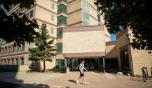 photo of student walking in front of NSC. 