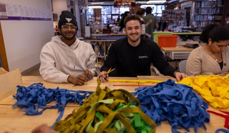 Two students participating in a day of service at Stitch Buffalo. 