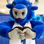 Victor E. Bull makes a heart with his hands. 