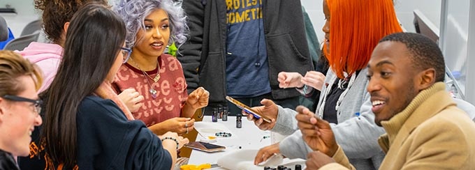 Students enjoy end-of-the-semester activities at the Silverman Library as part of the UB Libraries' Stress Relief Days in December 2019. The offerings included therapy dogs, ping pong, and aromatherapy bracelets. 